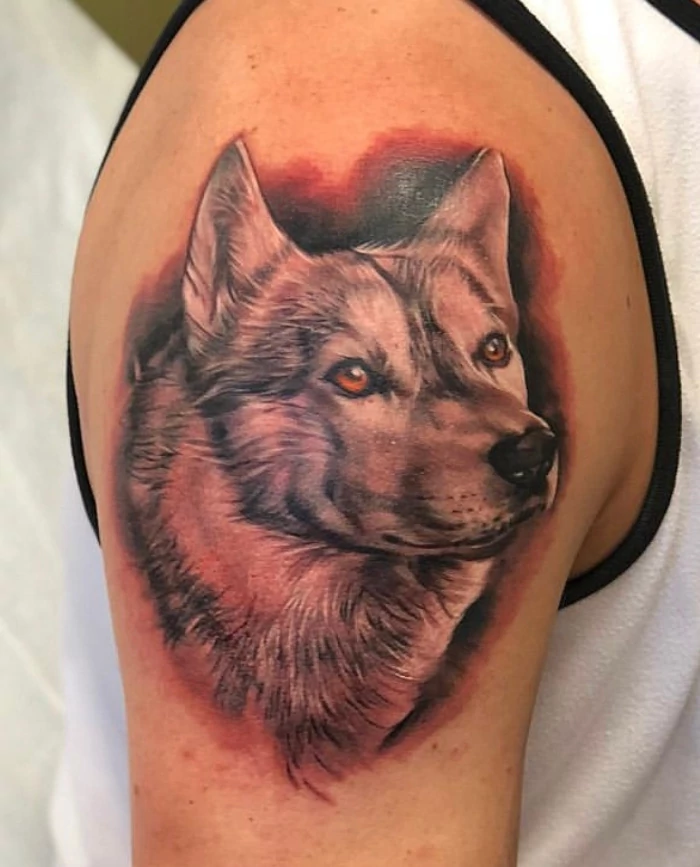 Wolf head shoulder tattoo done in black and grey ink by tattoo artist Russ Howie of Sacred Mandala Studio in Durham, NC.